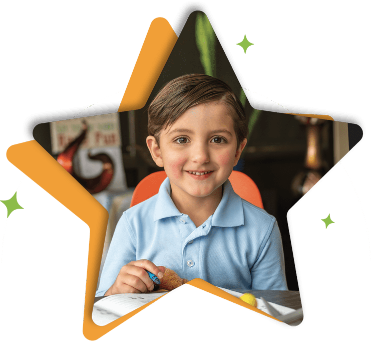 Boy smiling and working on workbook star